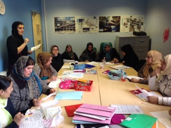 Photo of volunteers sitting around a table enjoying an activity