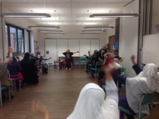 Photo of women waving their arms at Chairobics class