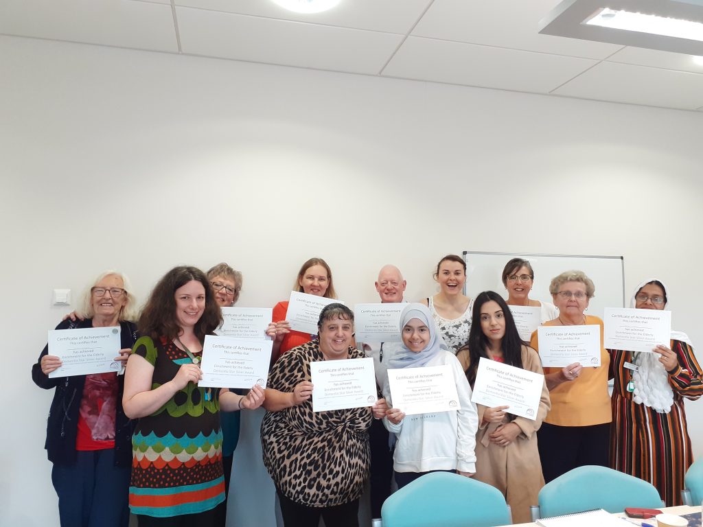 Photo of volunteers and staff at Darnall Well Being holding certificates from Dementia Silver Award training