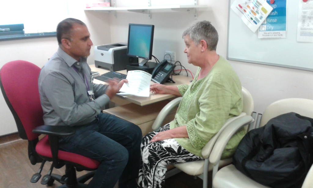 Photo of Waqas, one of our Senior Health Workers, talking with a client