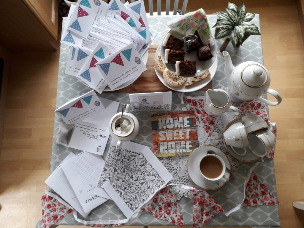 Photo of a table set for afternoon tea, with the contents of a VE Day themed activity pack