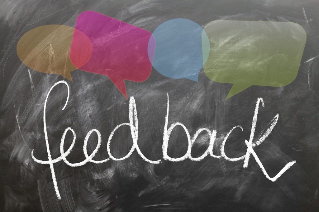 Blackboard showing the word Feedback and some speech bubbles