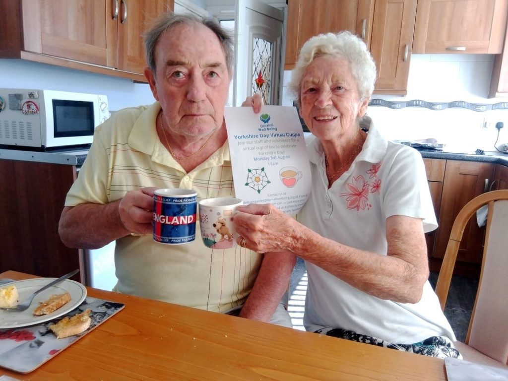 Photo of a couple with their cups of tea