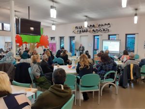 photo of people sitting around tables at our AGM