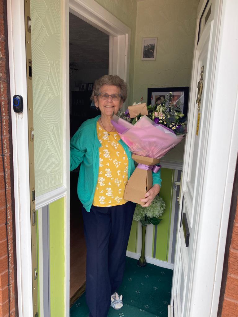 photo of woman holding bouquet of flowers