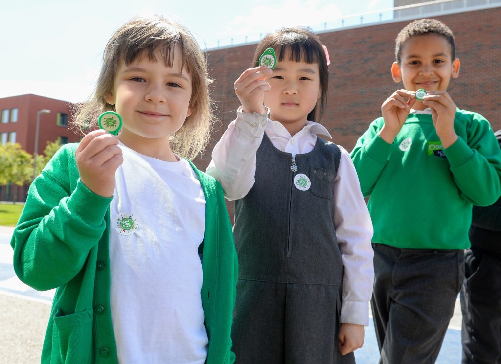 photo of children holding up tokens