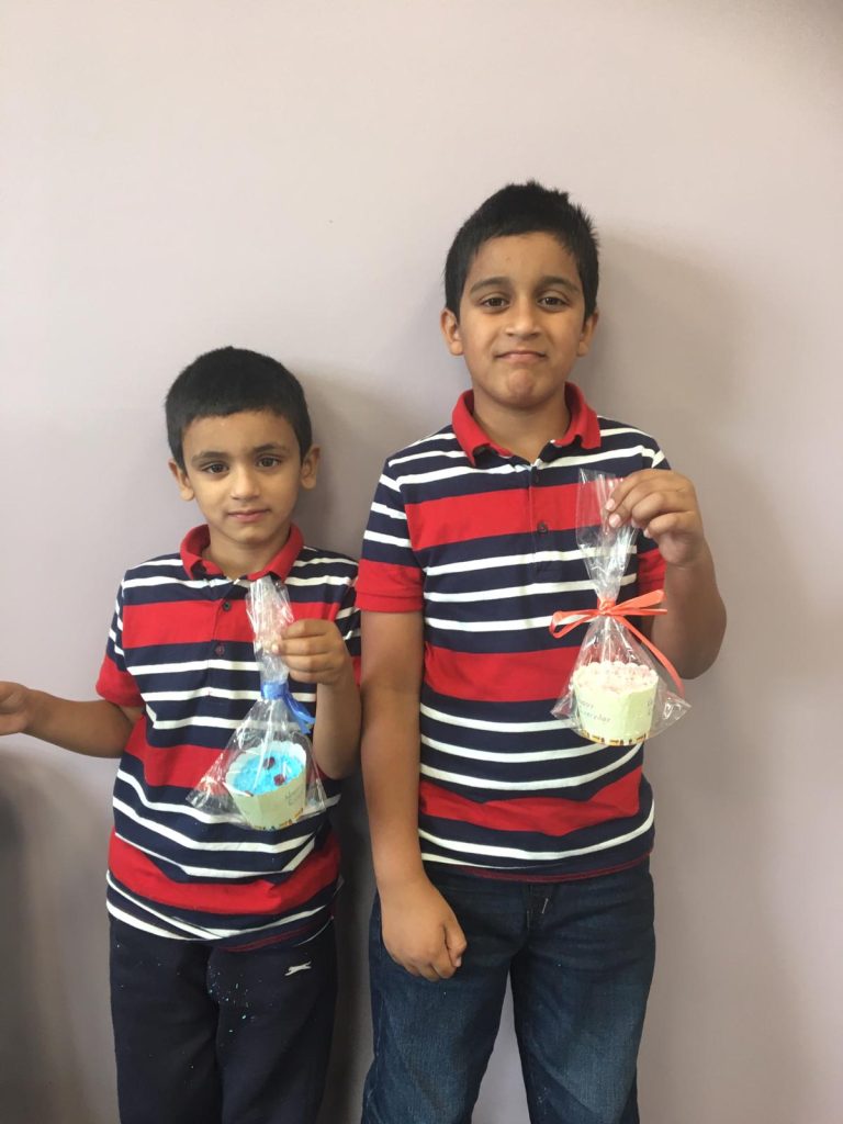 photo of 2 boys holding bath bombs