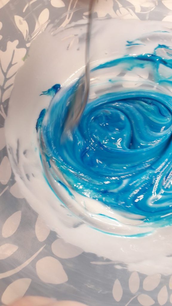 blue slime being mixed in a bowl
