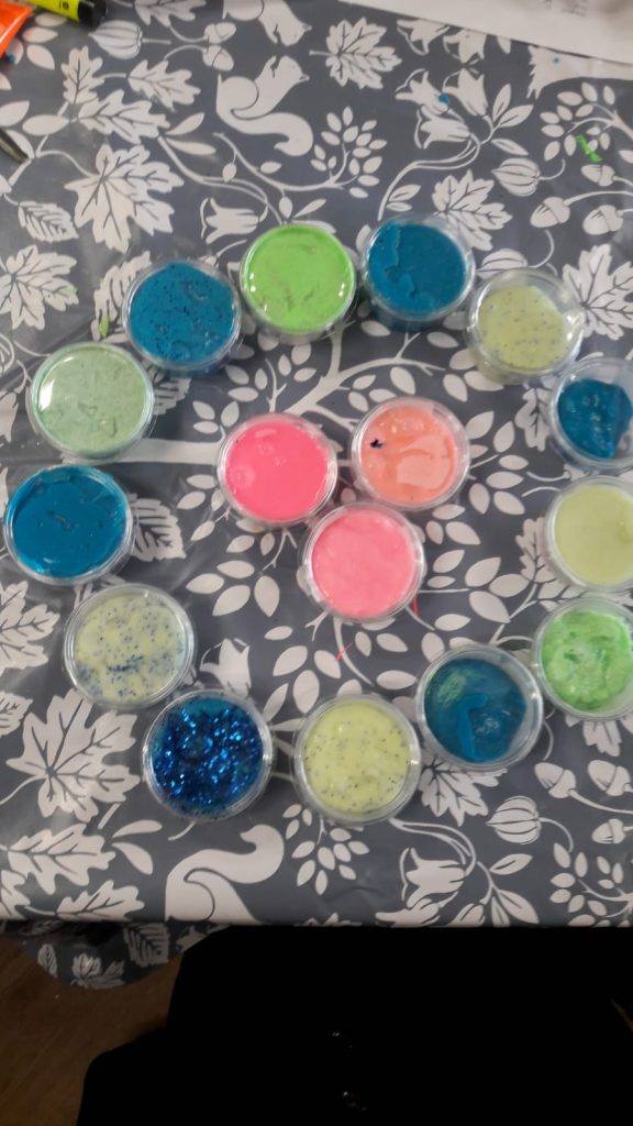 colourful pots of slime on a table