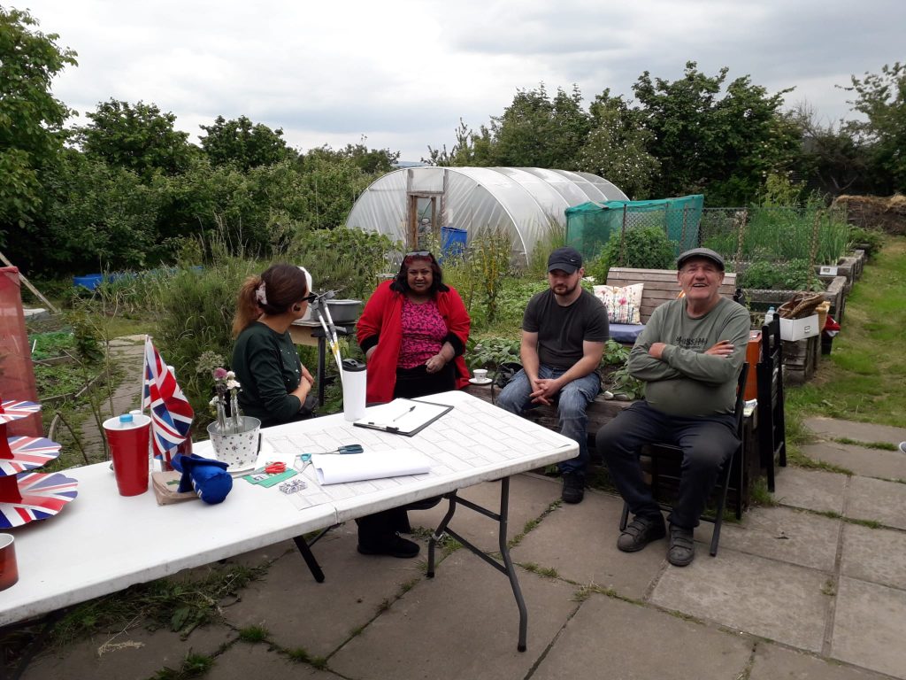 people sitting together at a community allotment