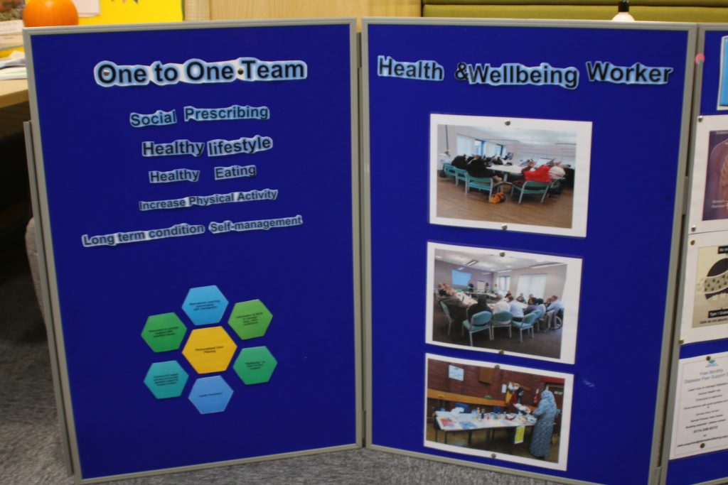 Information board displaying information about 1-1 team and health & wellbeing workers