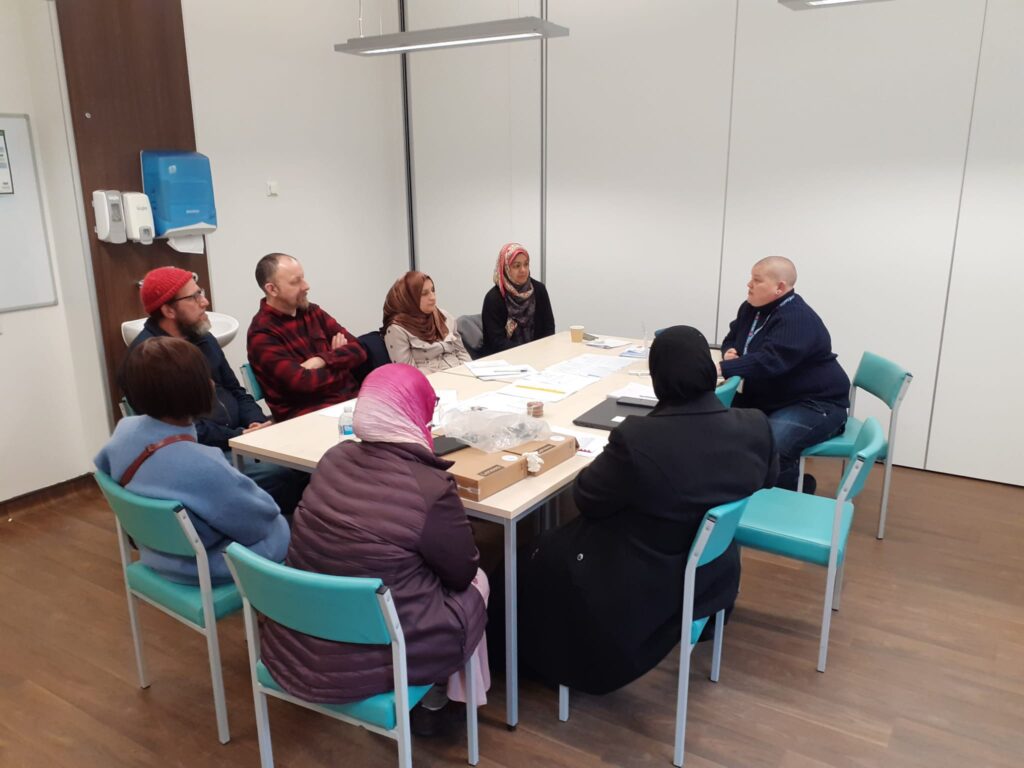 people seated around a table in a meeting room