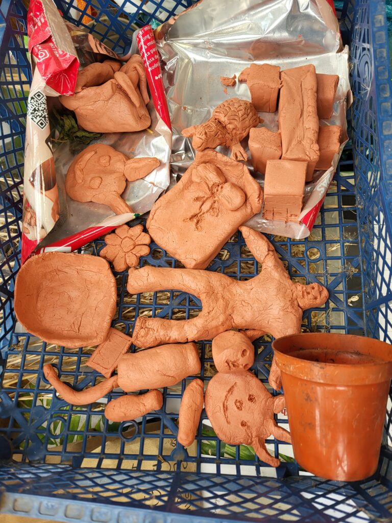a mixture of clay models, drying on a tray