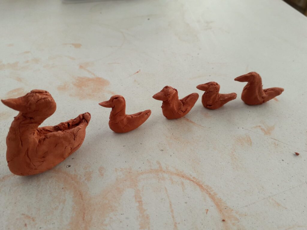 family of clay ducks