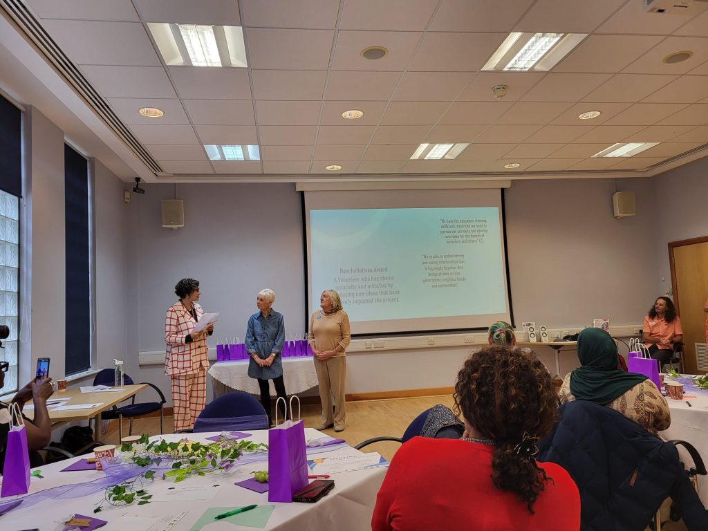 women standing in a meeting room in front of a projector screen