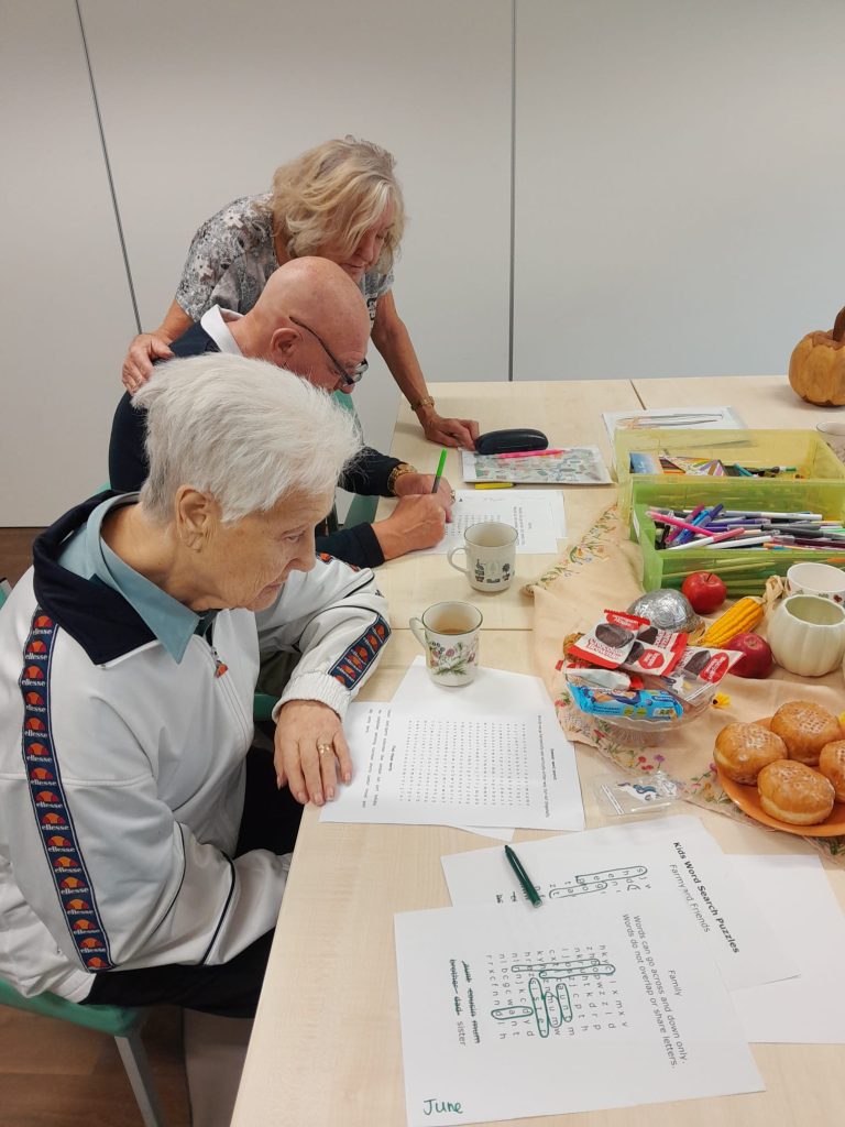 People doing wordsearches at a table