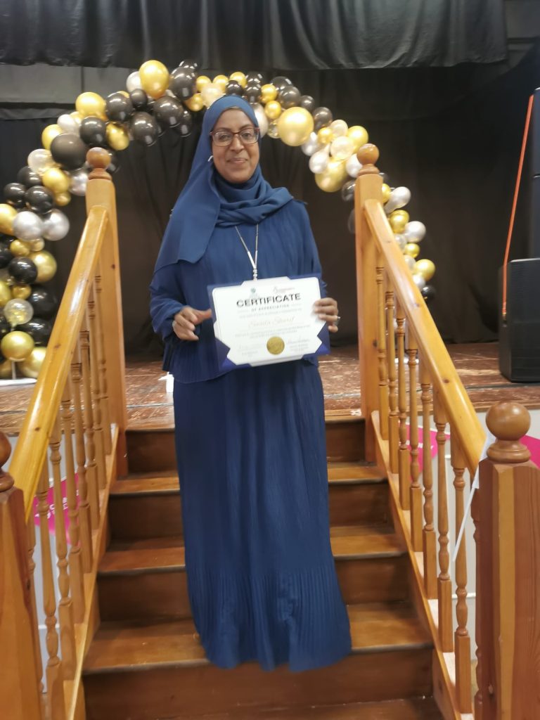 Saada smiling with her certificate