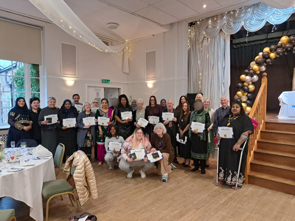 Volunteers with certificates - blurred faces