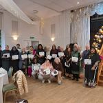 Volunteers with certificates - blurred faces