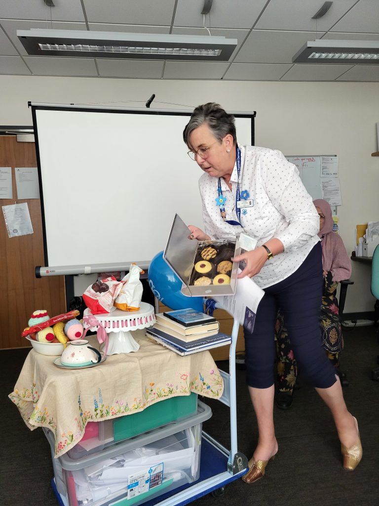 Woman with tea trolley and biscuits