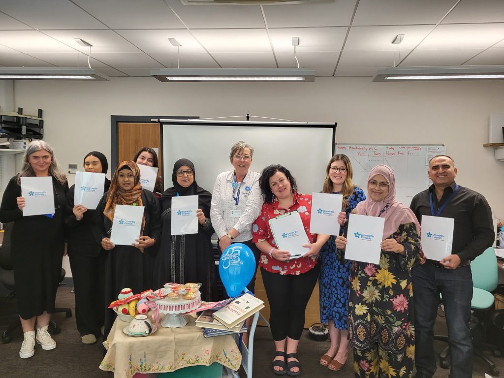 Team holding up Dementia Friends posters
