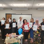 Team holding up Dementia Friends posters
