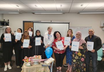 Team holding up Dementia Friends posters