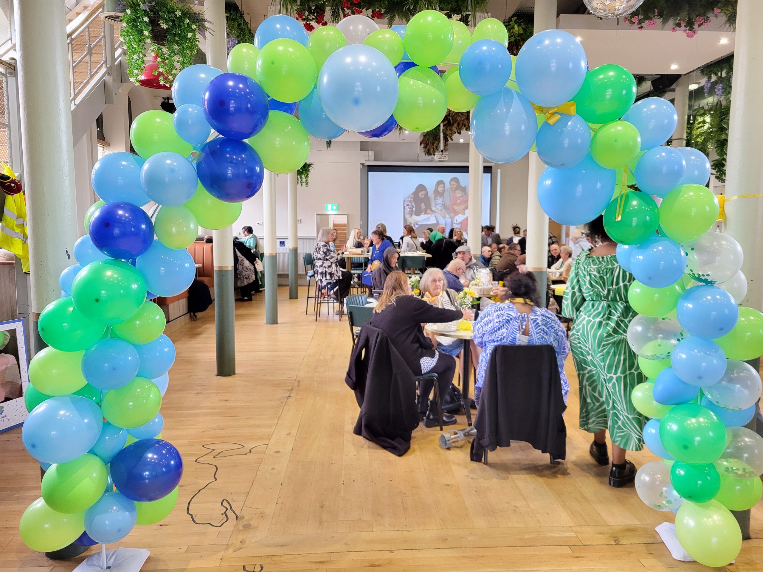 People sitting together framed by a balloon arch