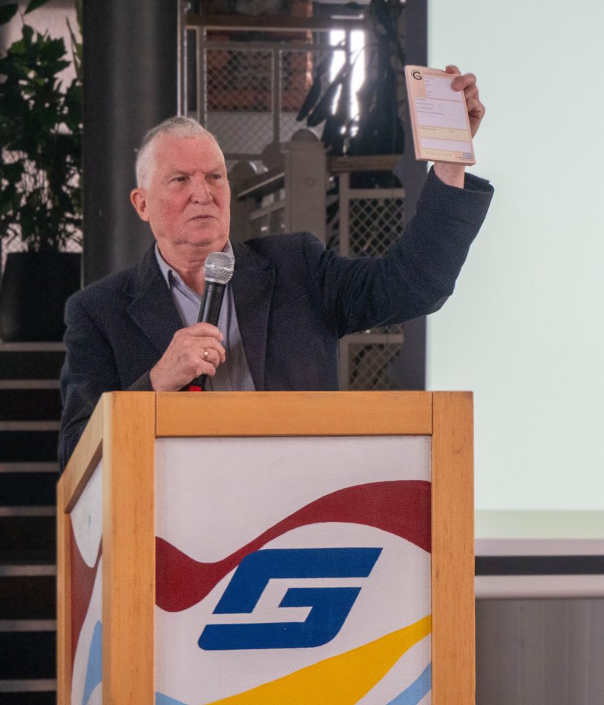Jack holds up a social prescribing prescription pad