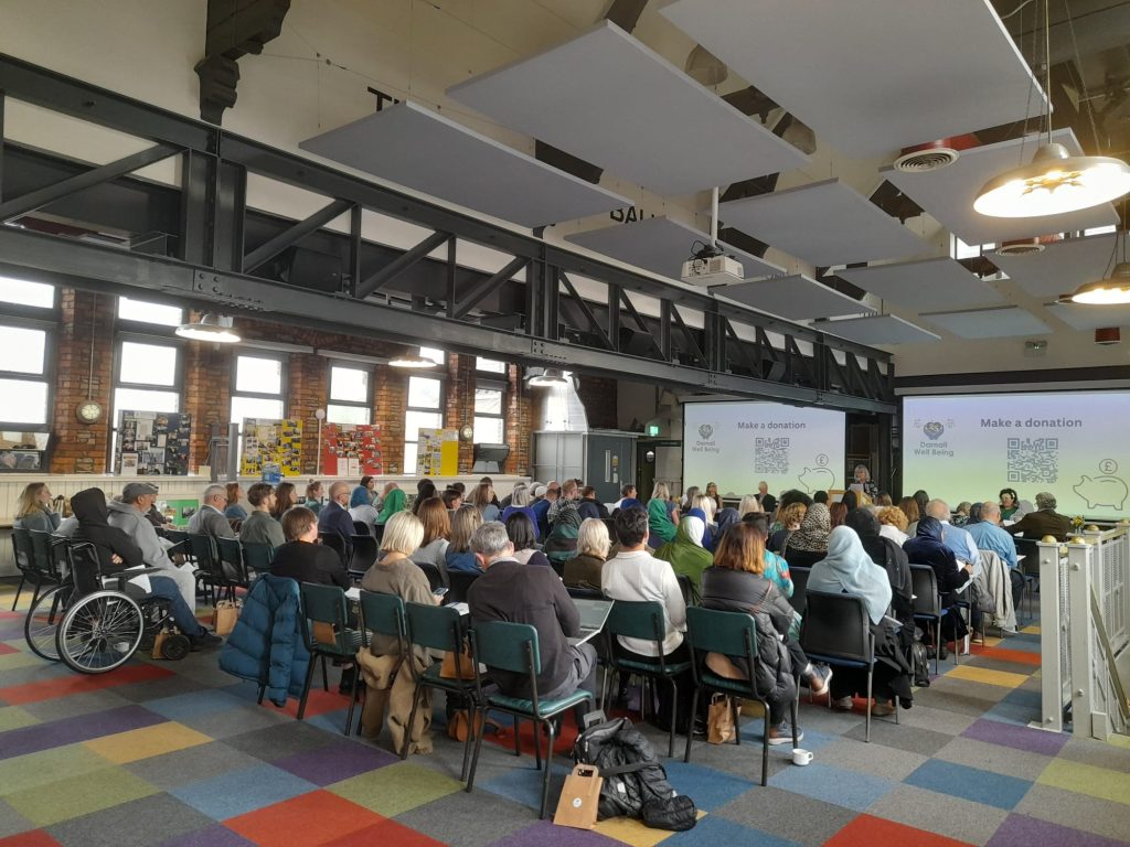 people seated at an AGM